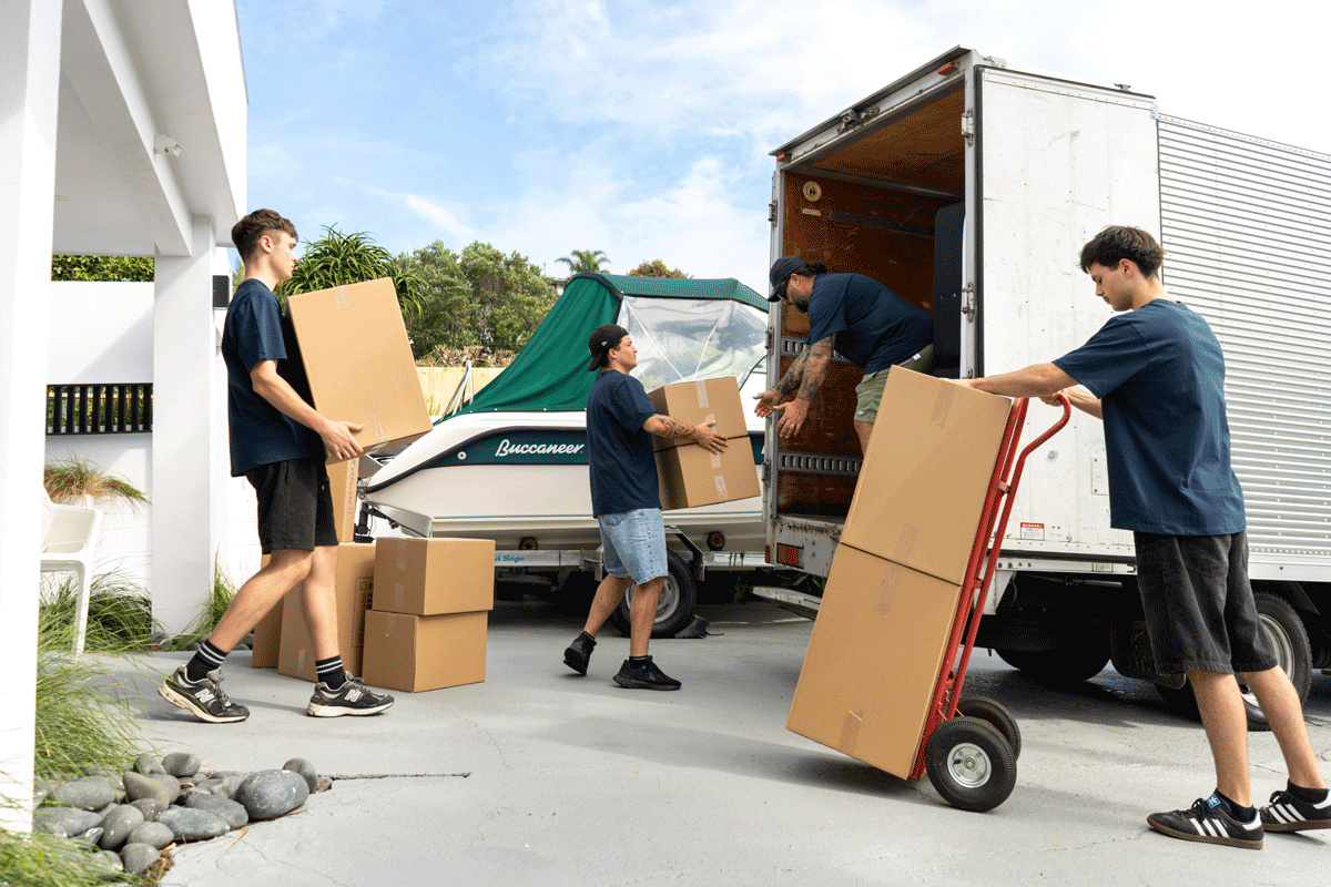 Professional movers loading packed boxes into a moving truck